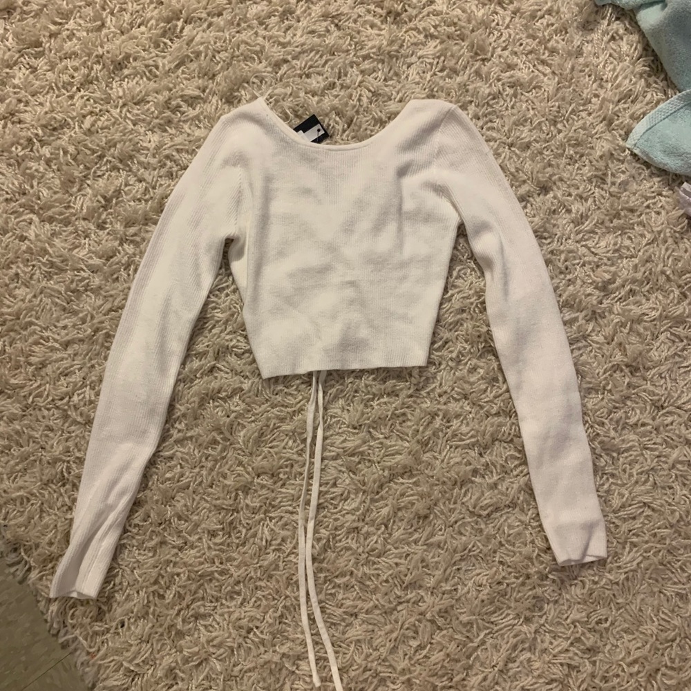 white knit top with tie up back.